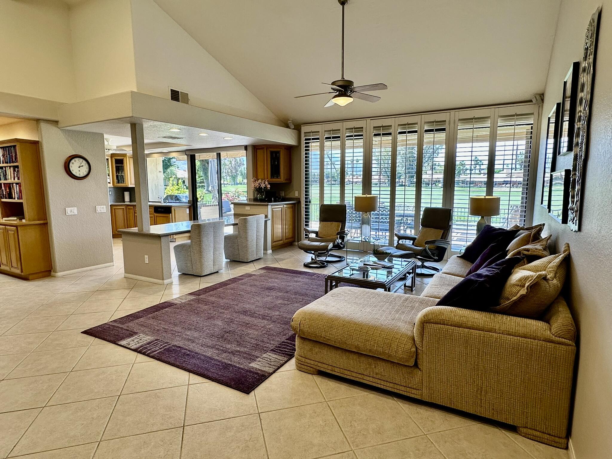 264 Ave Del Sol Palm Desert, CA 92260 - Photo 5 of 15 a living room with furniture and large windows