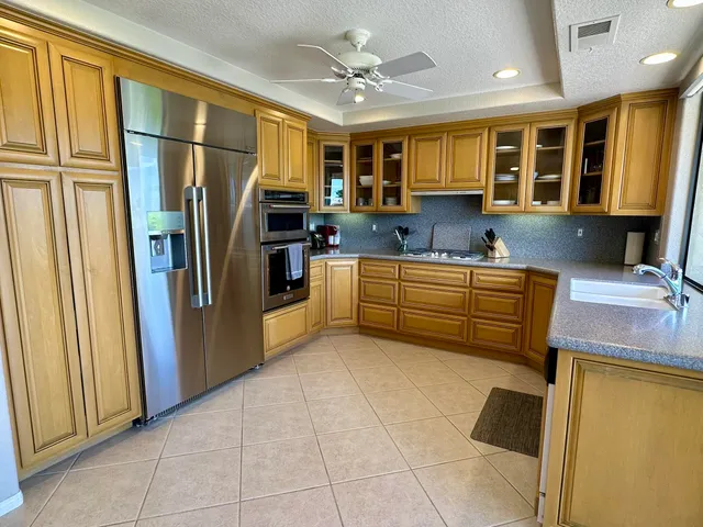 a kitchen with stainless steel appliances granite countertop a refrigerator and a sink