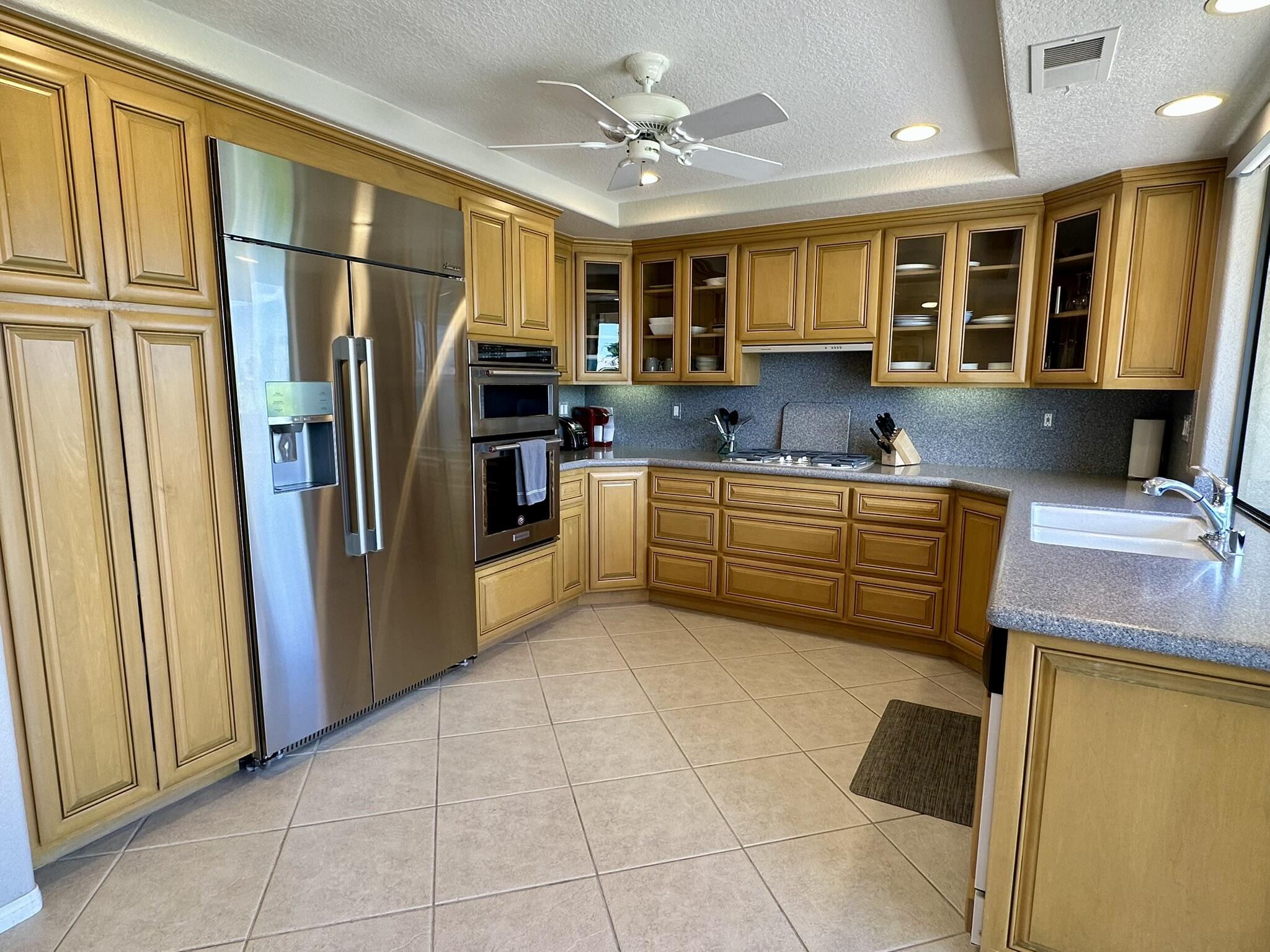 264 Ave Del Sol Palm Desert, CA 92260 - Photo 8 of 15 a kitchen with stainless steel appliances granite countertop a refrigerator and a sink