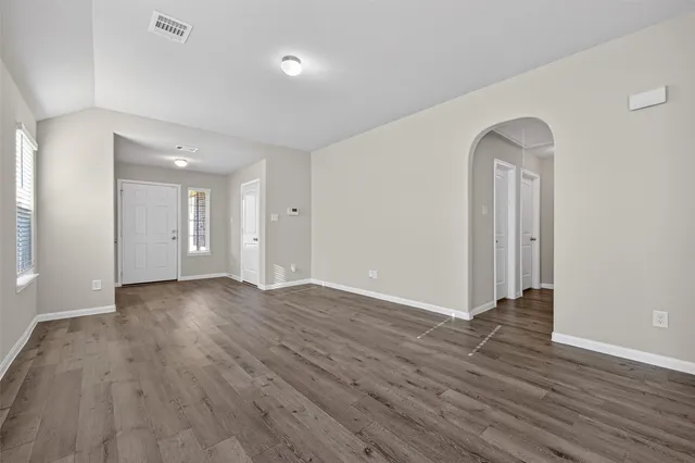 a view of a room with wooden floor and window