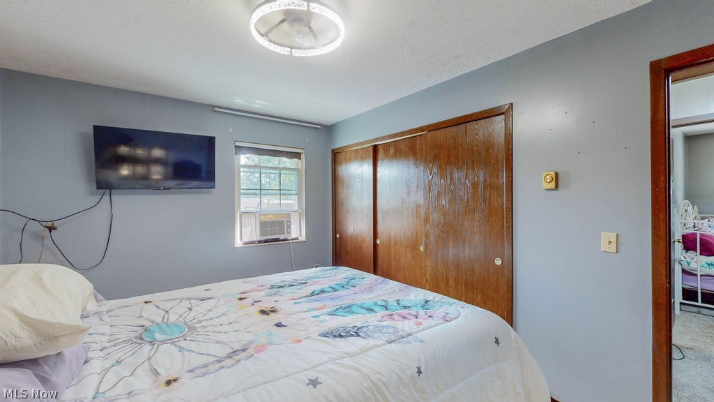 38667 Chestnut Ridge Road Elyria, OH 44035 - Photo 15 of 35 Bedroom with light gray walls, a ceiling-mounted light fixture, and wood-finish bi-fold closet doors