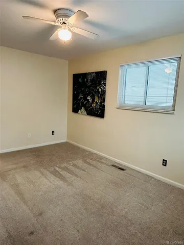 a view of room with a ceiling fan and window