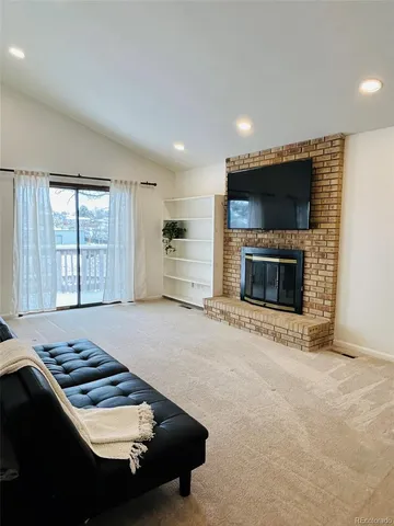 a kitchen with furniture and a fireplace