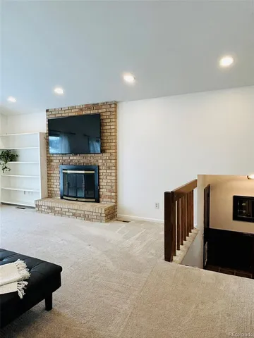 a view of an empty room with a fireplace