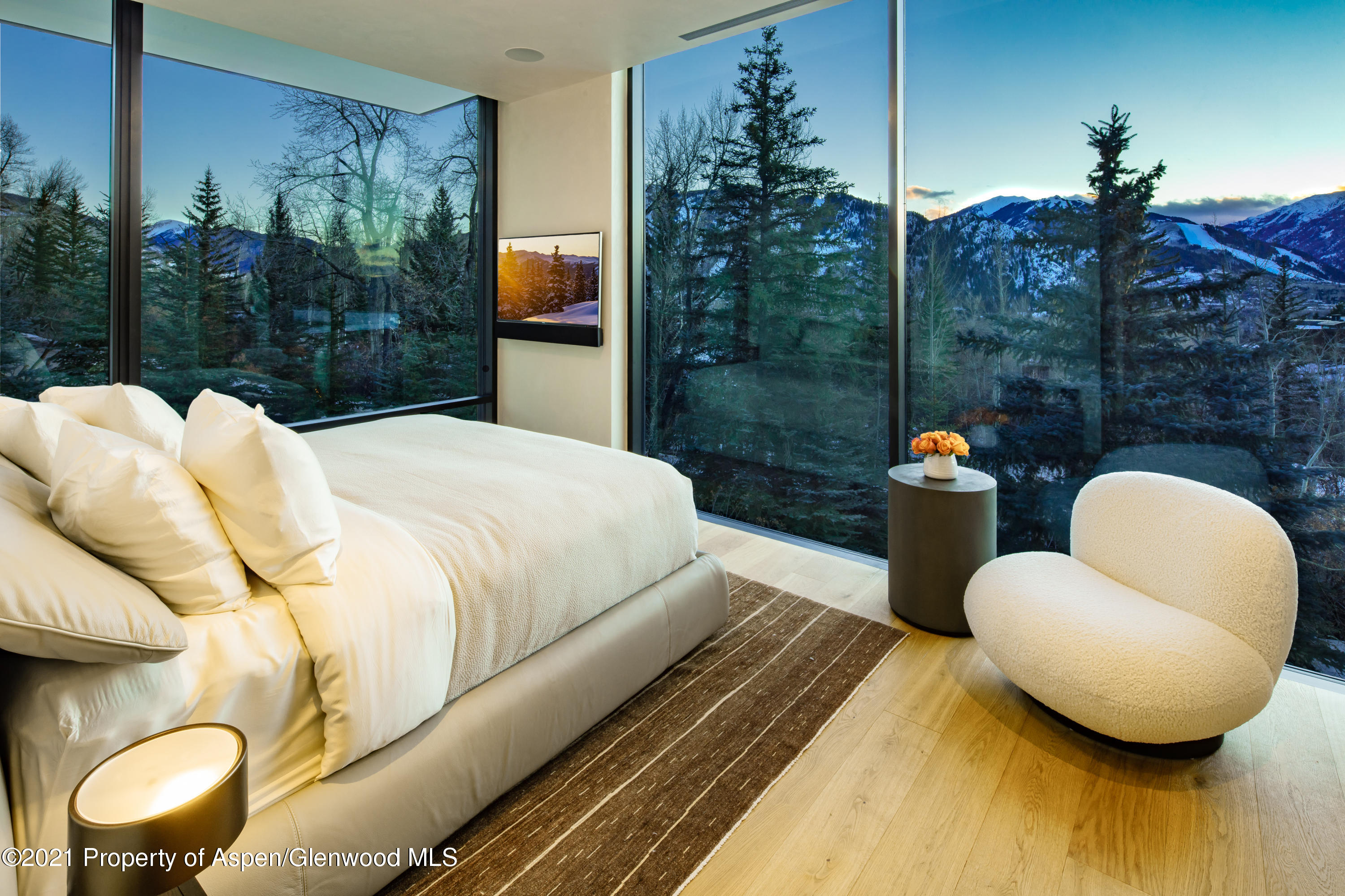 979 Red Mountain Road Aspen, CO 81612 - Photo 11 of 20 a bedroom with a bed and chandelier