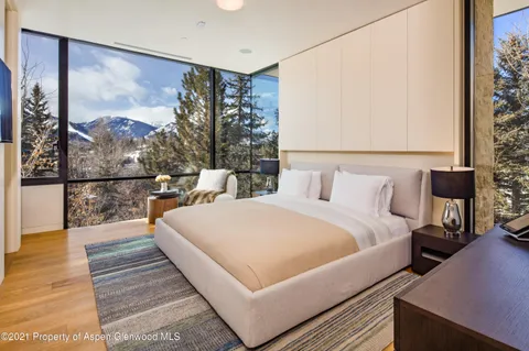 a bedroom with a bed and large window