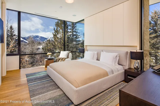 a bedroom with a bed and large window