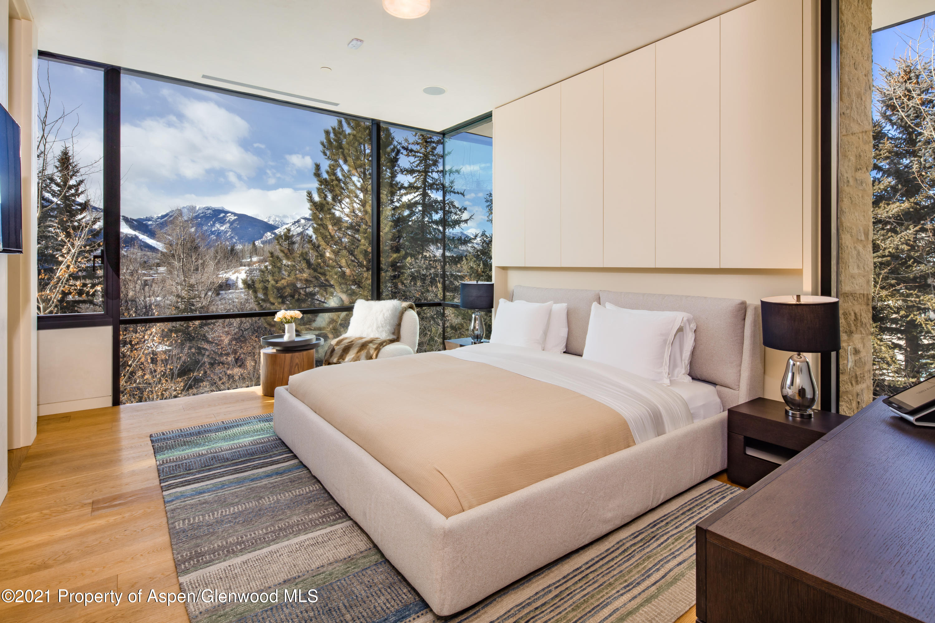 979 Red Mountain Road Aspen, CO 81612 - Photo 13 of 20 a bedroom with a bed and wooden floor