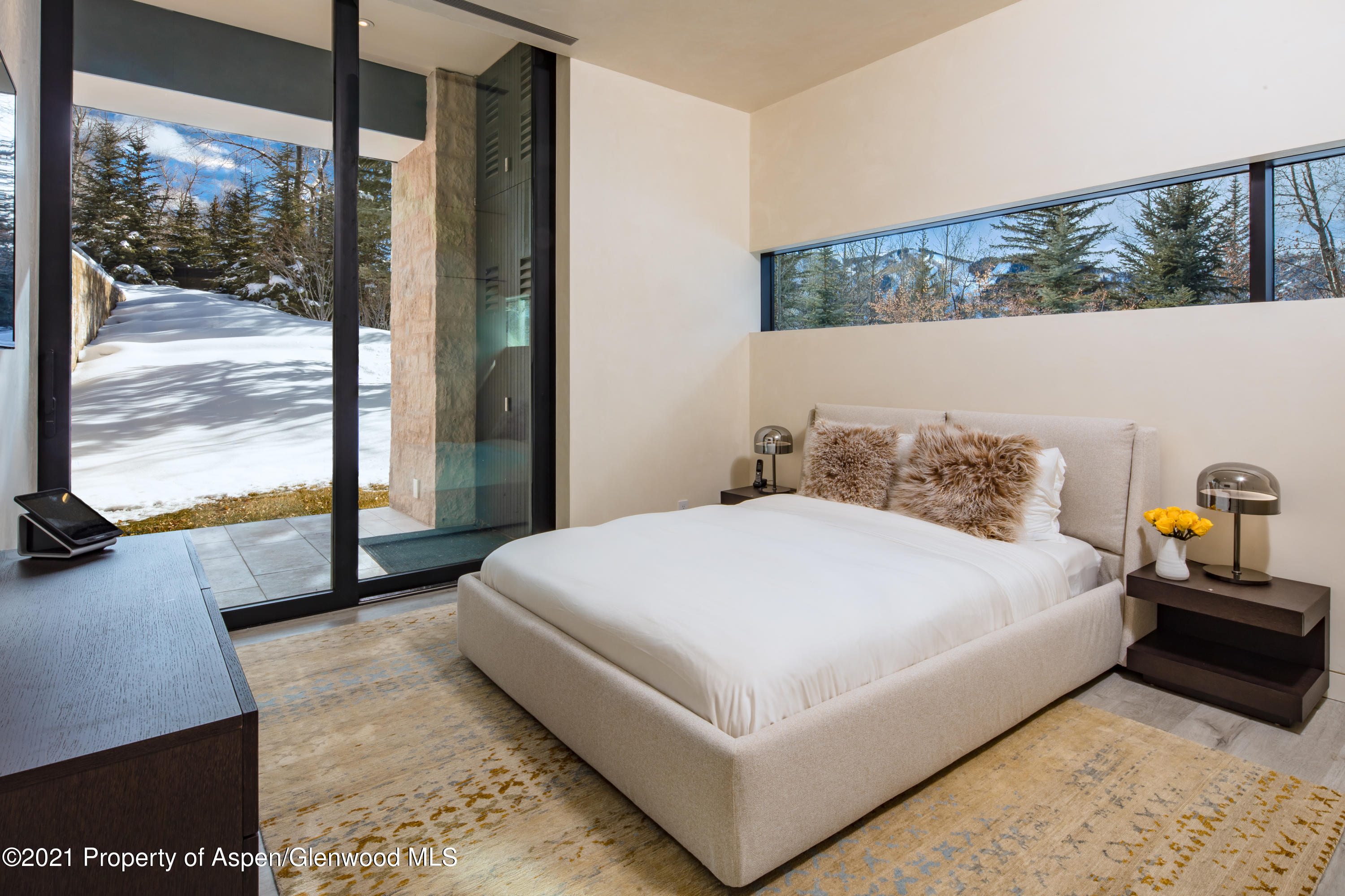 979 Red Mountain Road Aspen, CO 81612 - Photo 14 of 20 a bedroom with a bed and large window