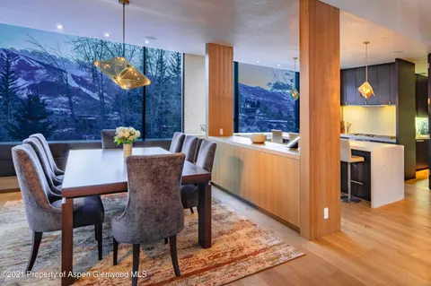 a view of a dining room with furniture a chandelier and wooden floor