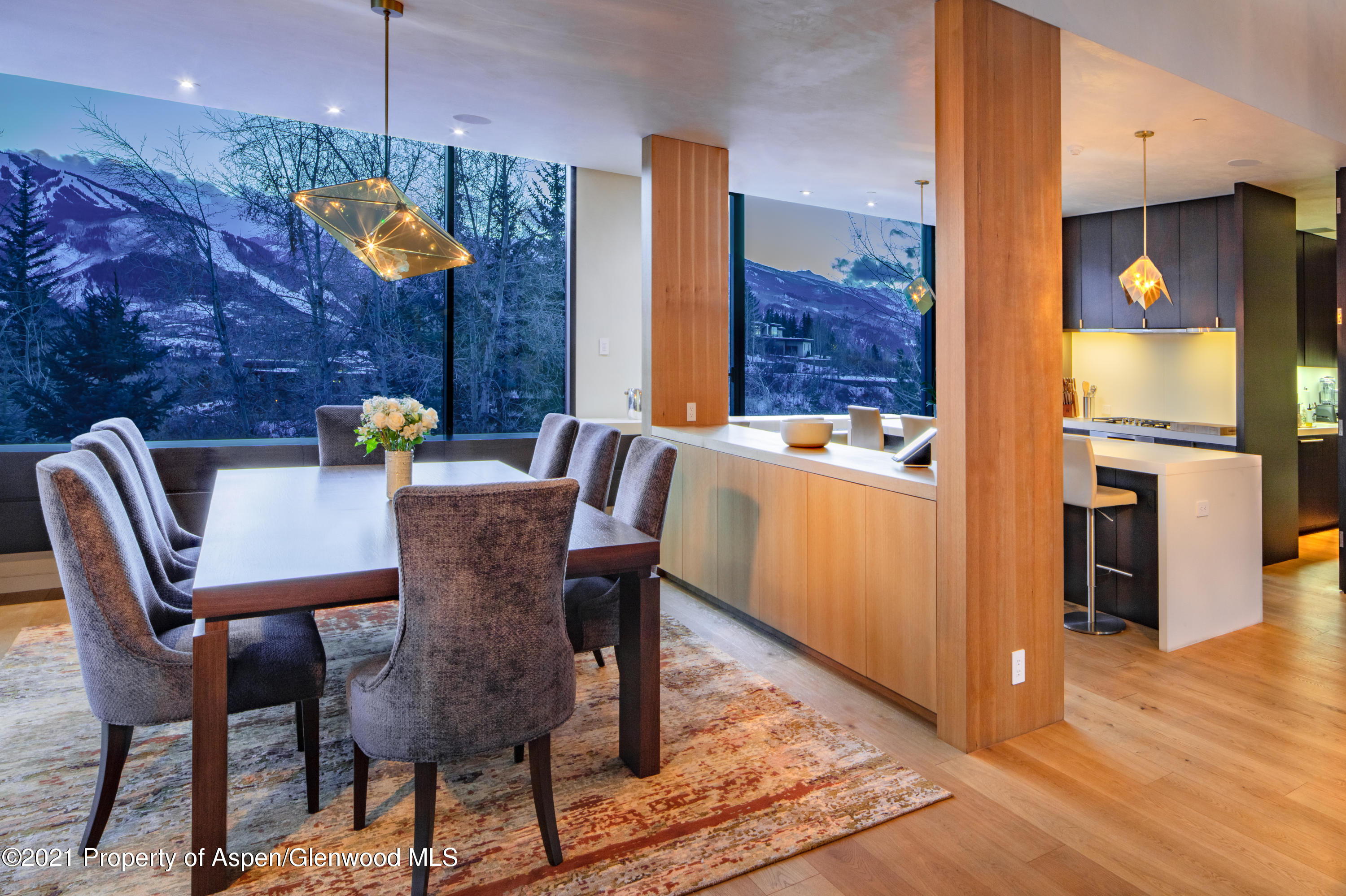 979 Red Mountain Road Aspen, CO 81612 - Photo 2 of 20 a view of a dining room with furniture a chandelier and wooden floor
