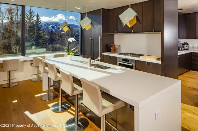 a large white kitchen with a stove a sink and a refrigerator