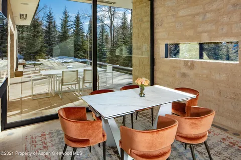 a outdoor dining space with furniture and wooden floor