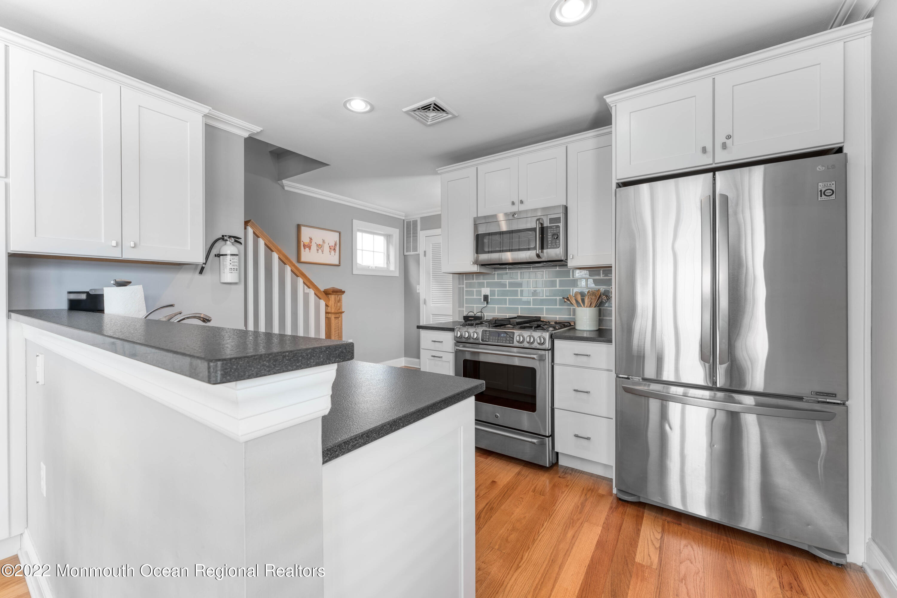 544 Brielle Road Manasquan, NJ 08736 - Photo 11 of 20 a kitchen with kitchen island granite countertop stainless steel appliances a refrigerator a stove top oven and a refrigerator
