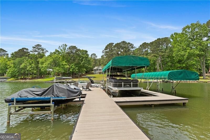 1041 Fox Chase Run Greensboro, GA 30642 - Photo 11 of 45 a view of a lake with couches in patio