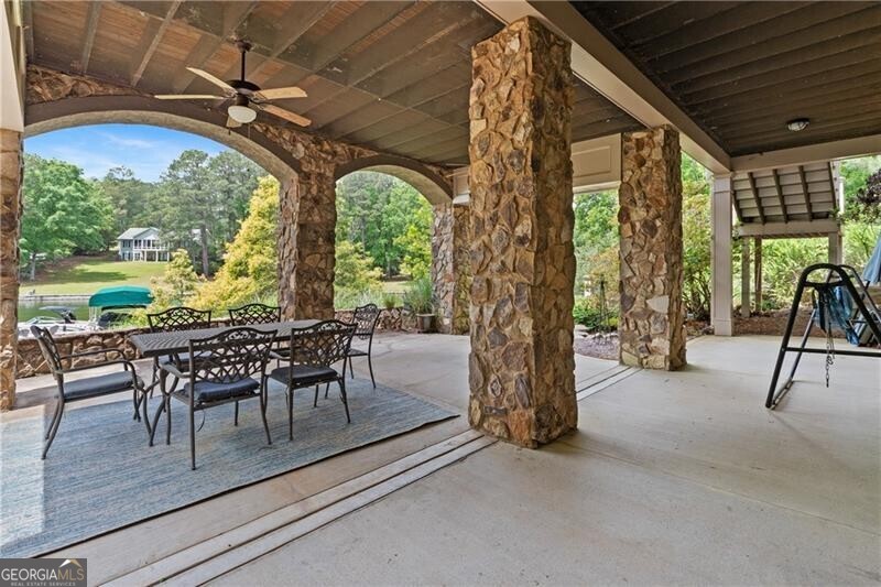 1041 Fox Chase Run Greensboro, GA 30642 - Photo 14 of 45 a view of a patio with dining table and chairs