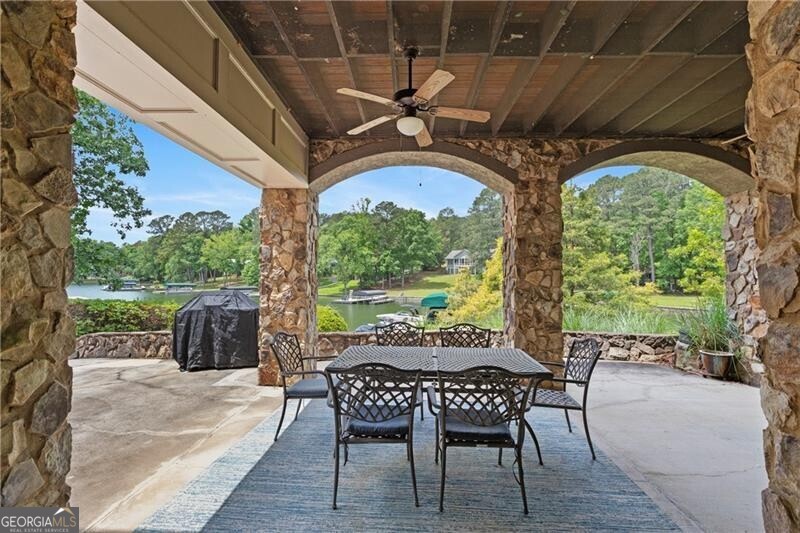 1041 Fox Chase Run Greensboro, GA 30642 - Photo 16 of 45 a view of a patio with table and chairs potted plants with wooden floor and fence
