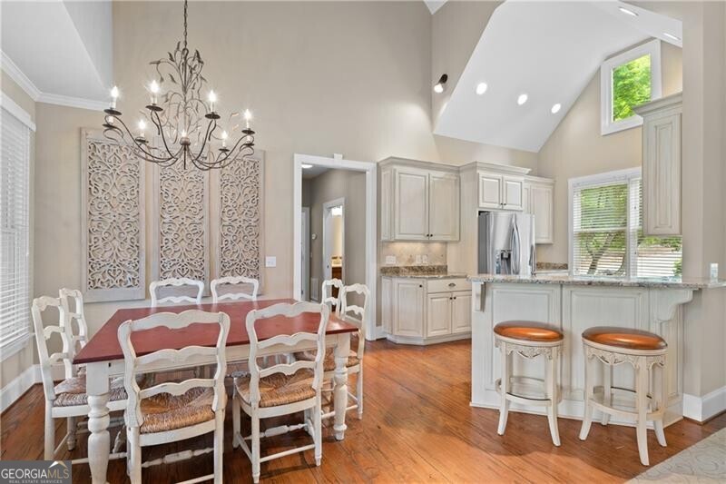1041 Fox Chase Run Greensboro, GA 30642 - Photo 25 of 45 a dining room with furniture a chandelier and wooden floor