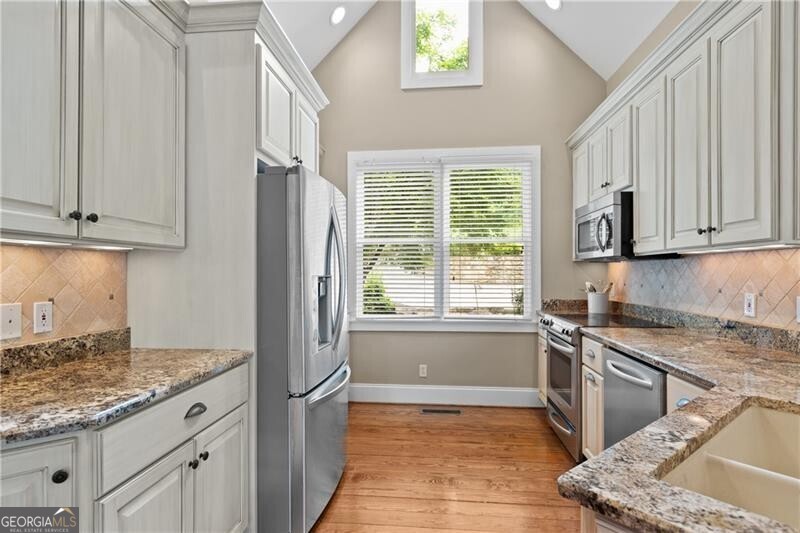1041 Fox Chase Run Greensboro, GA 30642 - Photo 26 of 45 a kitchen with stainless steel appliances granite countertop a sink stove and refrigerator
