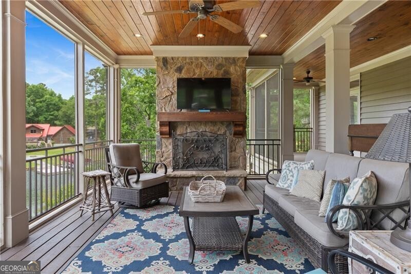 1041 Fox Chase Run Greensboro, GA 30642 - Photo 30 of 45 a living room with furniture a fireplace and a floor to ceiling window