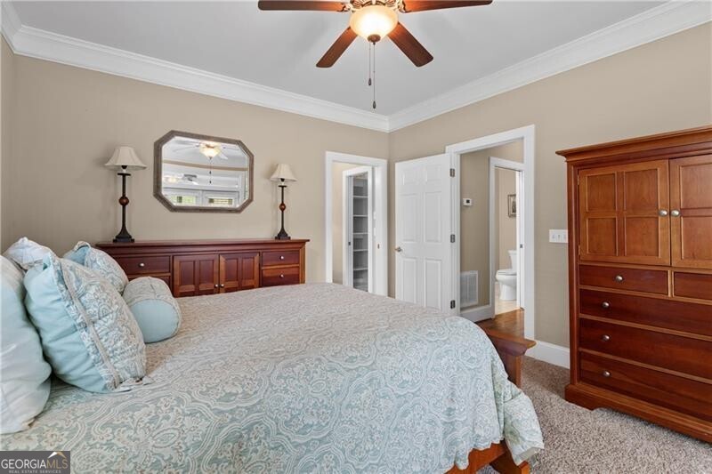 1041 Fox Chase Run Greensboro, GA 30642 - Photo 33 of 45 a bedroom with a bed and a chandelier