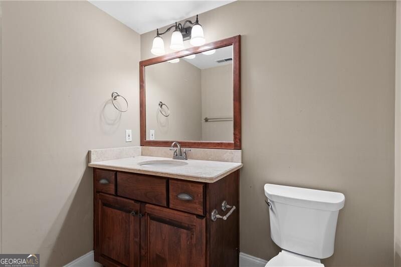 1041 Fox Chase Run Greensboro, GA 30642 - Photo 36 of 45 a bathroom with a toilet a sink and mirror