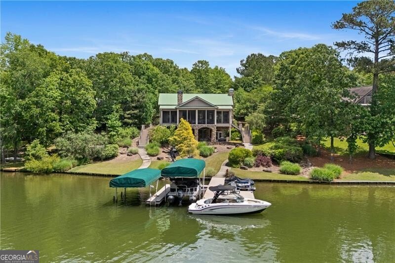 1041 Fox Chase Run Greensboro, GA 30642 - Photo 5 of 45 a view of a lake with a house swimming pool and outdoor space