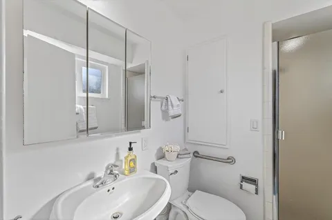 a bathroom with a sink a vanity and a shower