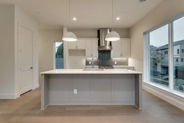 a kitchen with kitchen island a sink stainless steel appliances and window
