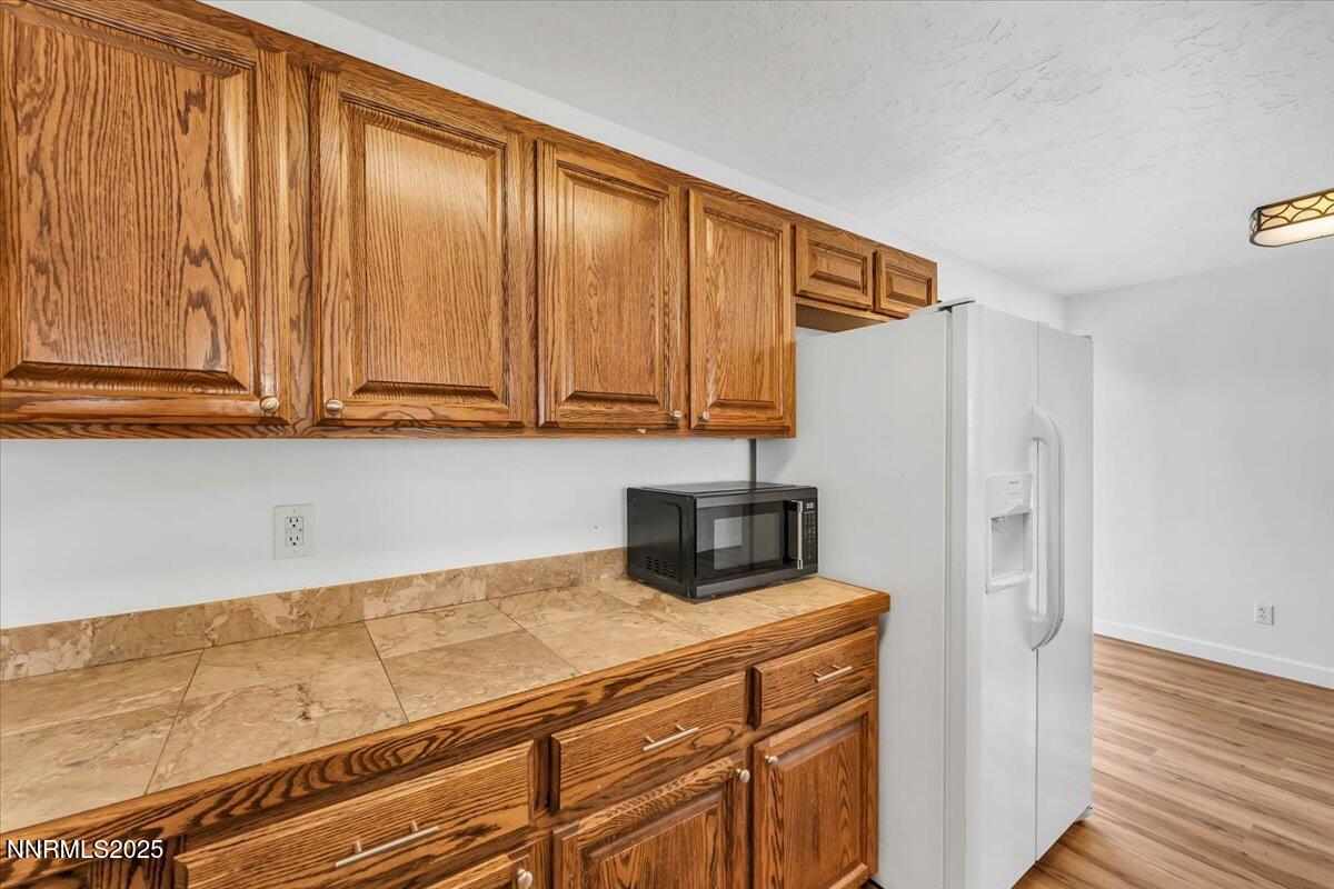 988 Bench Road Fallon, NV 89406 - Photo 14 of 54 a kitchen with a refrigerator and cabinets
