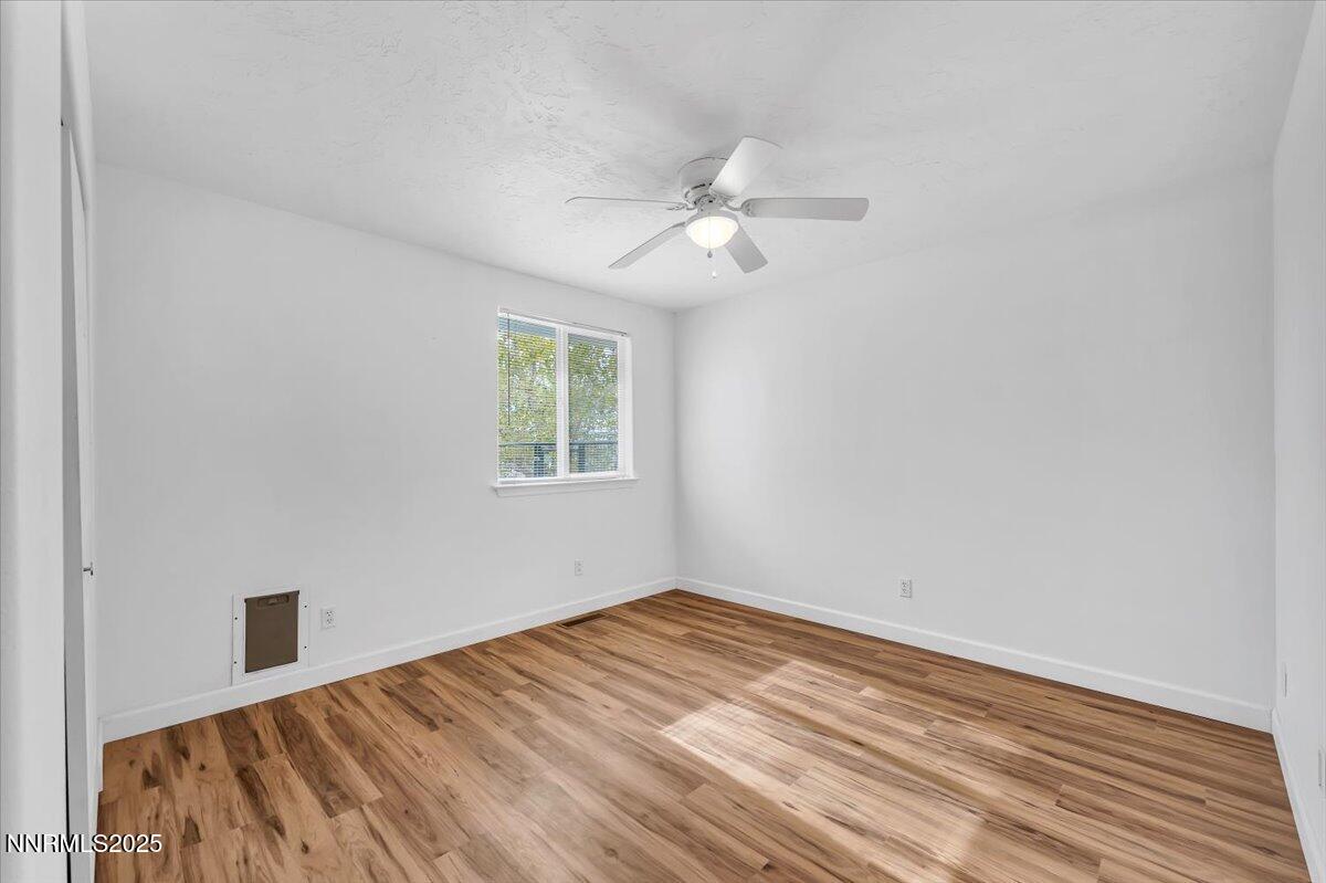 988 Bench Road Fallon, NV 89406 - Photo 20 of 54 a view of empty room with wooden floor and fan
