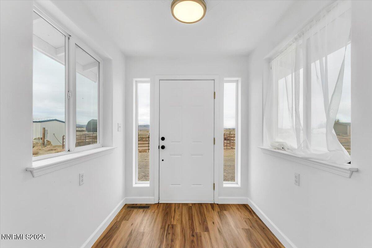 988 Bench Road Fallon, NV 89406 - Photo 2 of 54 a view of front door with wooden floor and a window