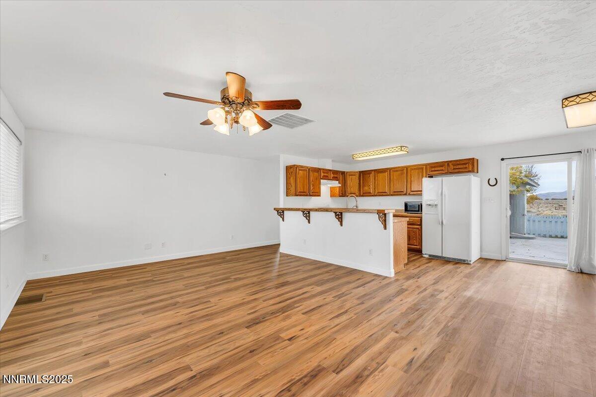 988 Bench Road Fallon, NV 89406 - Photo 4 of 54 a view of a kitchen with wooden floor and a ceiling fan