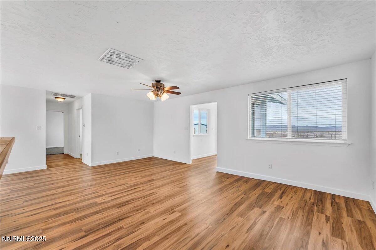 988 Bench Road Fallon, NV 89406 - Photo 6 of 54 wooden floor in an empty room with a window
