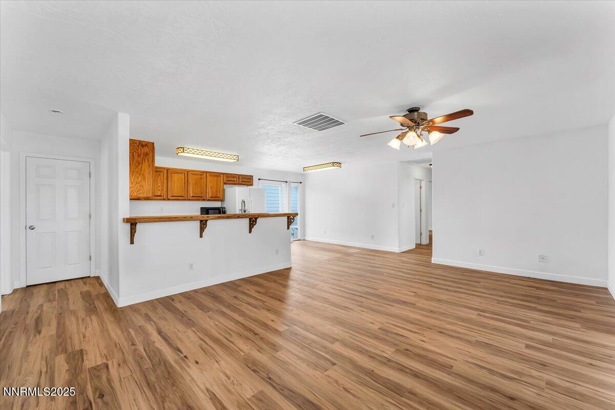 988 Bench Road Fallon, NV 89406 - Photo 7 of 54 a view of a room with wooden floor and a ceiling fan