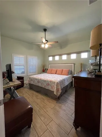 a bedroom with a bed and lamp