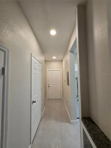 a view of hallway with a rug and a stove