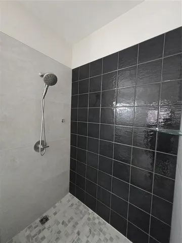 a bathroom with a granite countertop sink a toilet and a mirror