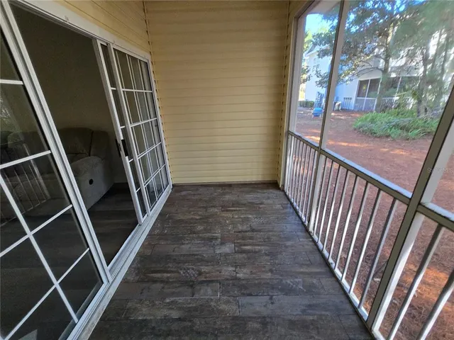 a view of a room with wooden floor and brick walls