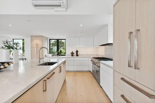 a kitchen with a sink cabinets and window