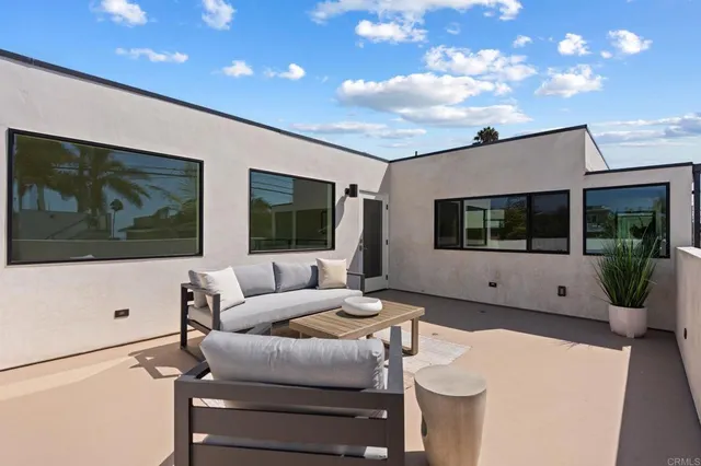 a aerial view of a large building with a lot of trees and plants