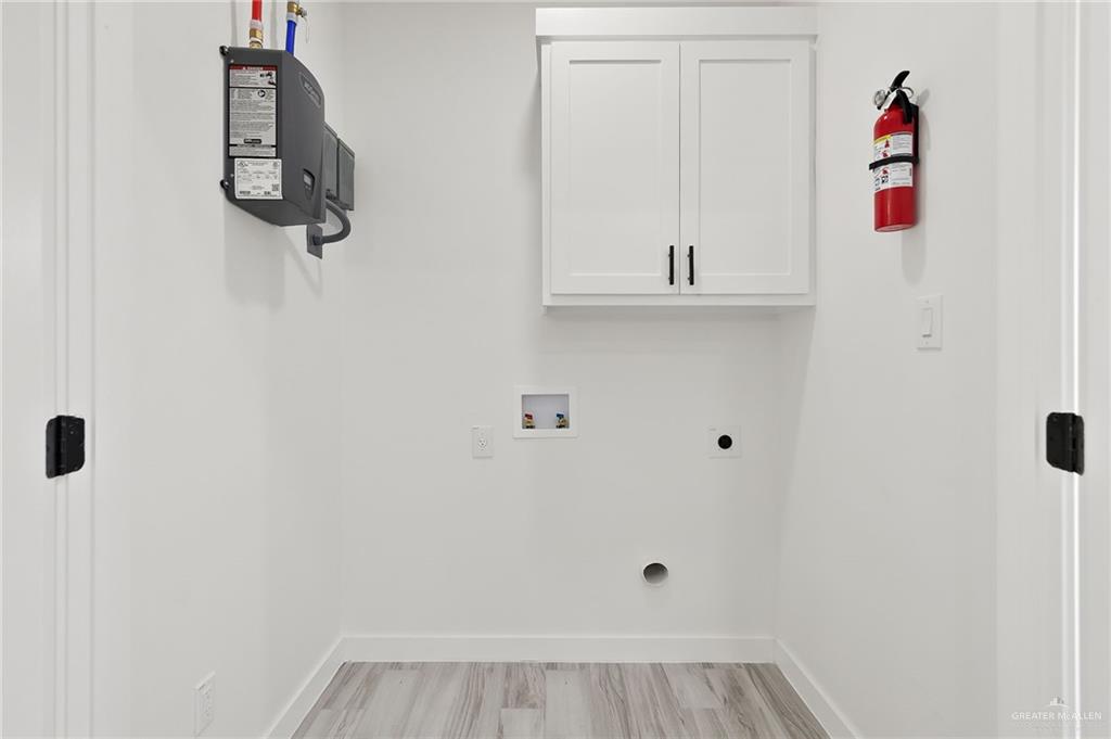 518 East E Loop, Unit 7 Harlingen, TX 78550 - Photo 7 of 14 a view of walk in closet with clothes