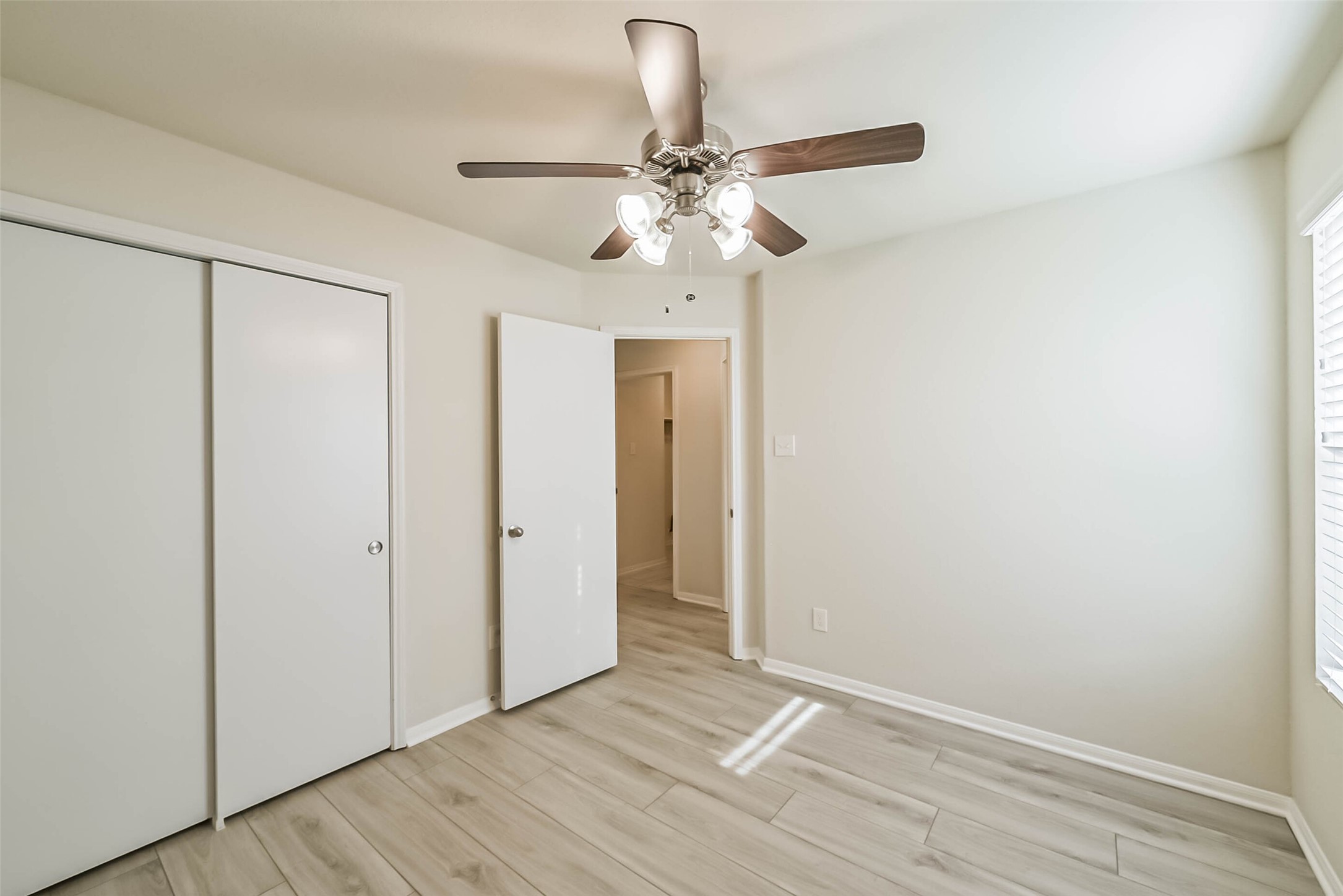 2630 Zephyr Lane Rosenberg, TX 77471 - Photo 27 of 33 a view of an empty room with window and wooden floor