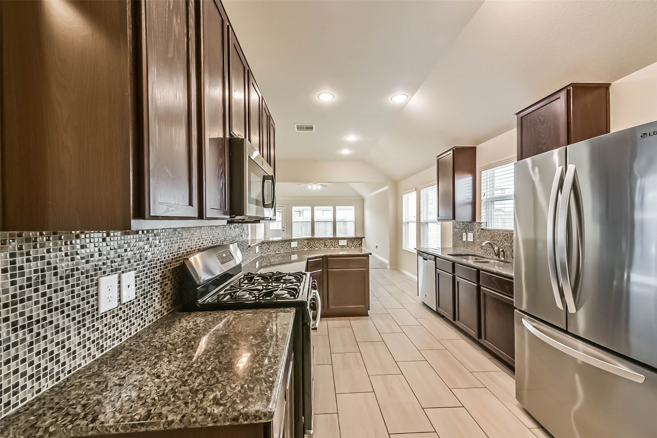 2630 Zephyr Lane Rosenberg, TX 77471 - Photo 9 of 33 a kitchen with stainless steel appliances granite countertop a refrigerator a stove and a sink