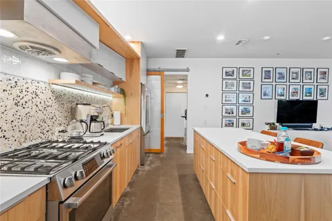 a kitchen with stainless steel appliances granite countertop a stove and a sink