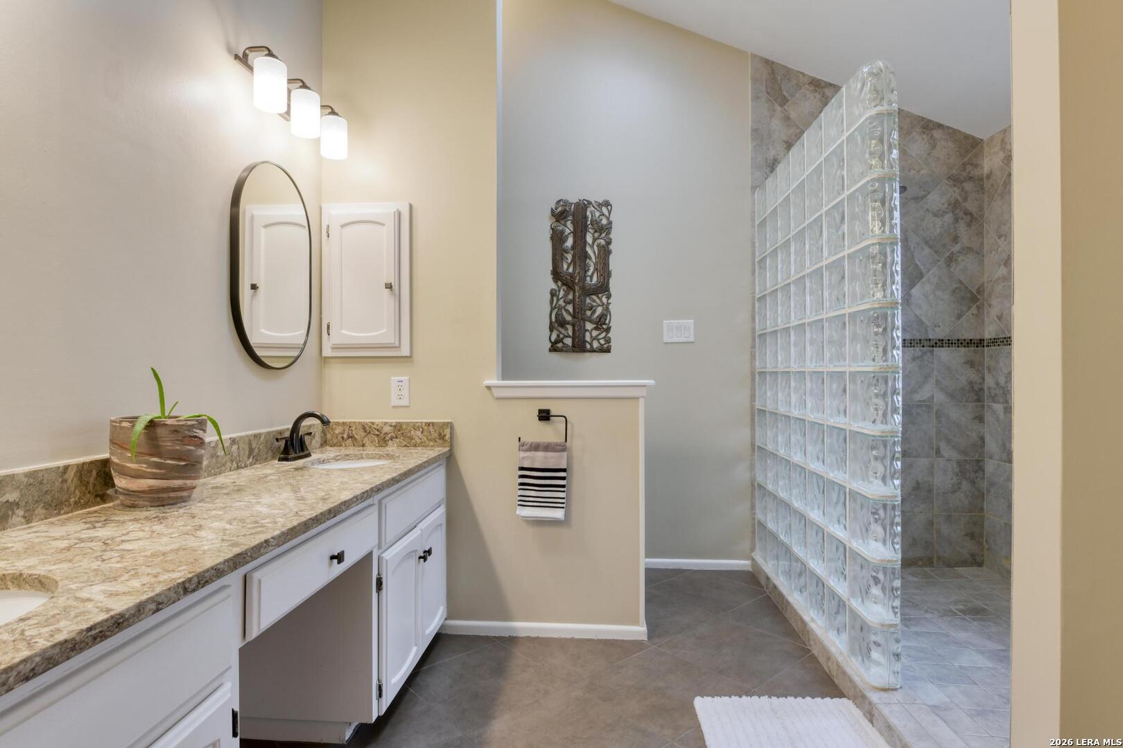 3154 Morning Trail San Antonio, TX 78247 - Photo 11 of 41 a bathroom with a granite countertop sink and a mirror