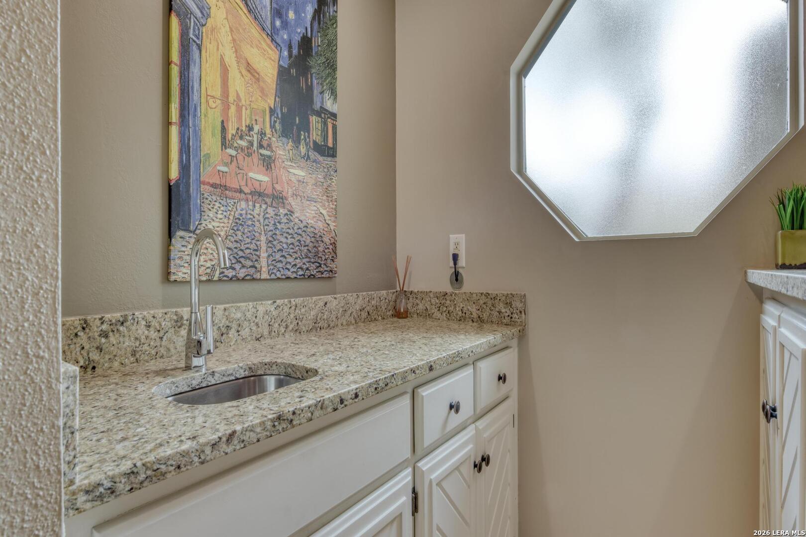 3154 Morning Trail San Antonio, TX 78247 - Photo 25 of 41 a bathroom with a granite countertop sink and a mirror