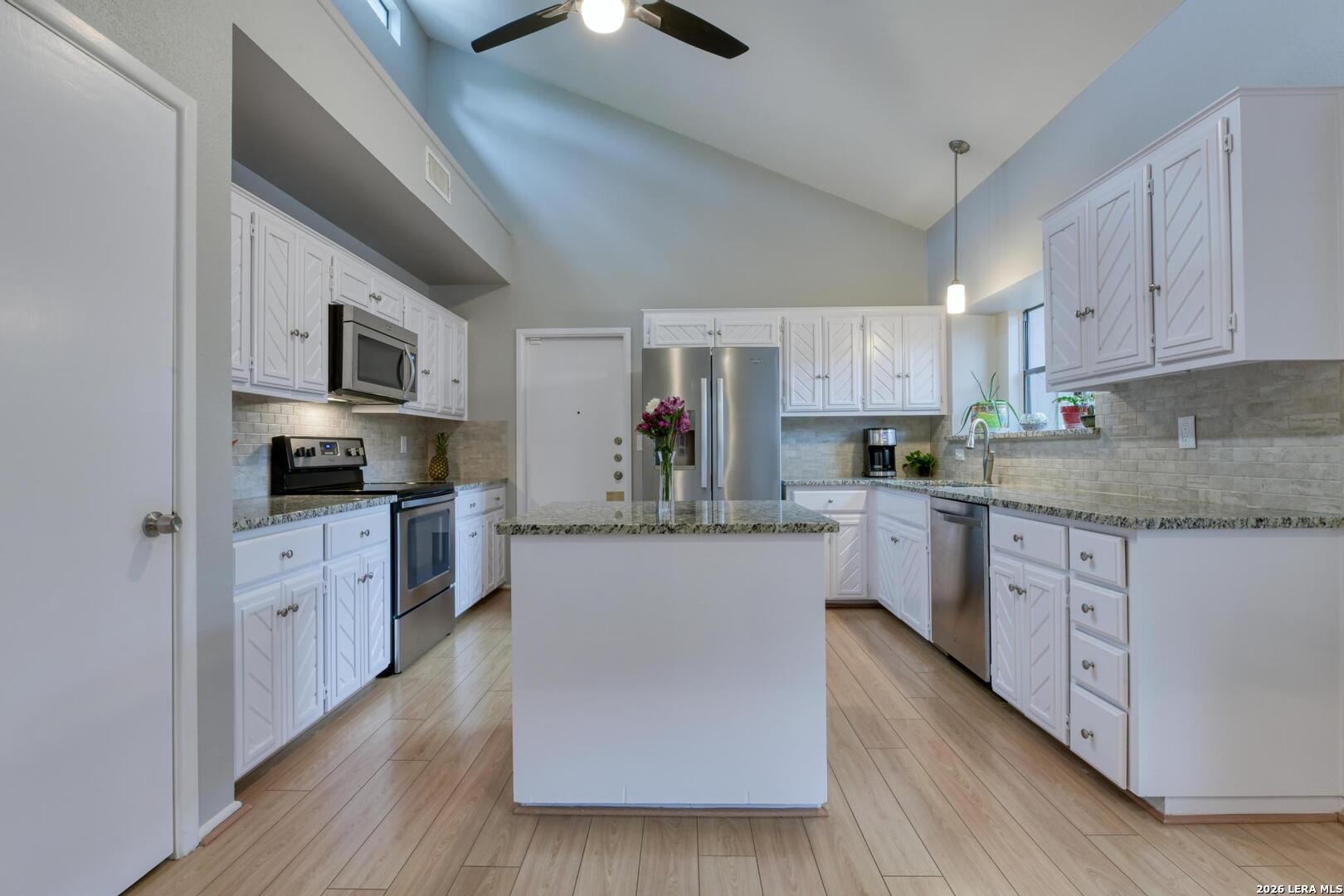 3154 Morning Trail San Antonio, TX 78247 - Photo 28 of 41 a kitchen with granite countertop a refrigerator stove top oven and sink