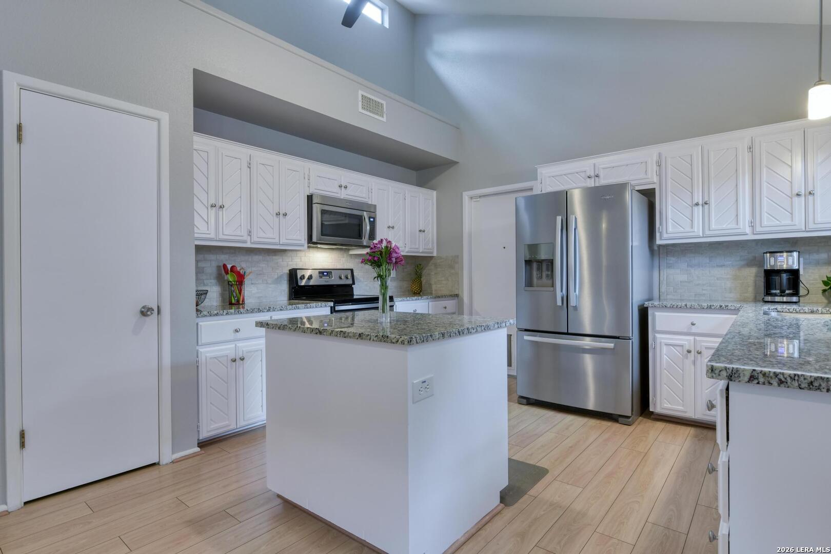 3154 Morning Trail San Antonio, TX 78247 - Photo 5 of 41 a kitchen with stainless steel appliances granite countertop a refrigerator stove a sink and a microwave