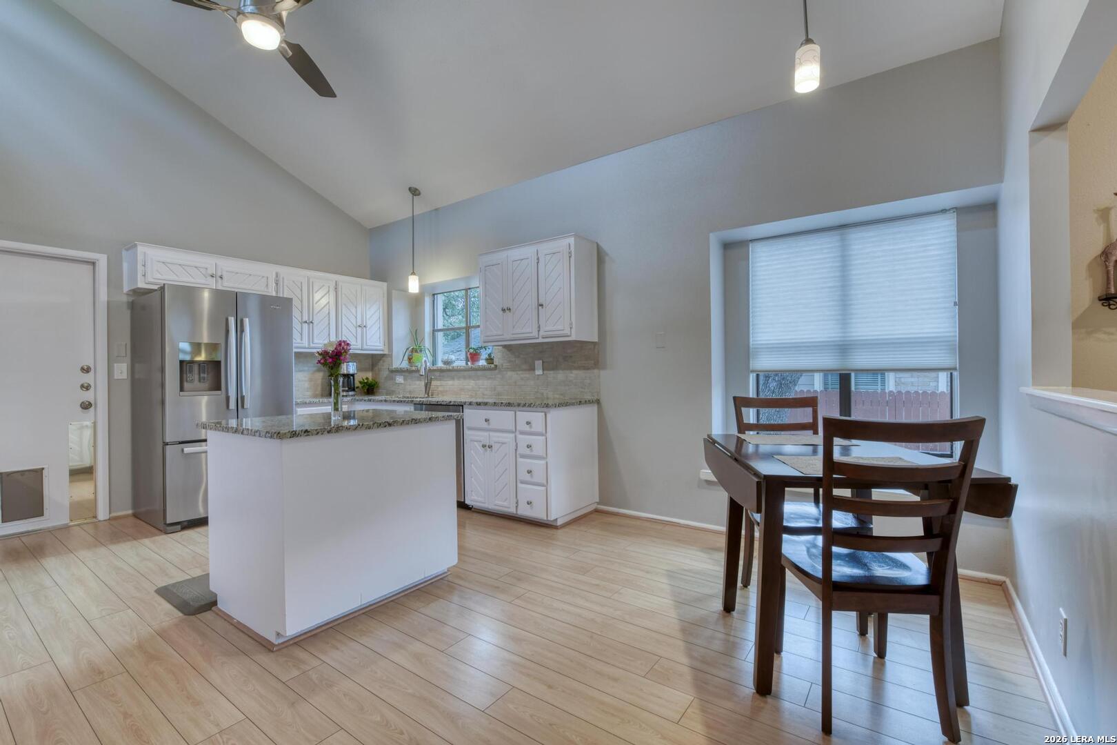 3154 Morning Trail San Antonio, TX 78247 - Photo 8 of 41 a kitchen with stainless steel appliances wooden floors dining table and chair